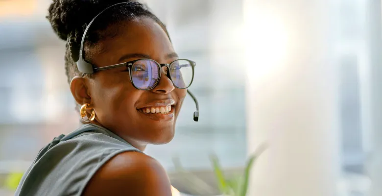 A UMA Student Services representative smiling while assisting a student.