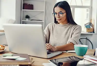 A woman typing on a computer