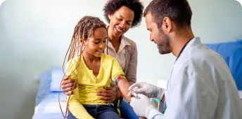 A phlebotomy technician working with a patient