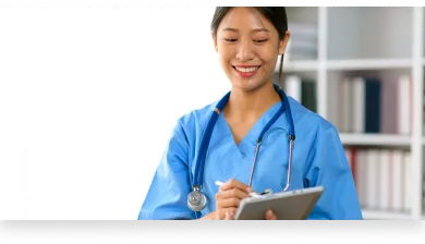 a healthcare student updating a patient’s chart as part of her medical assistant program