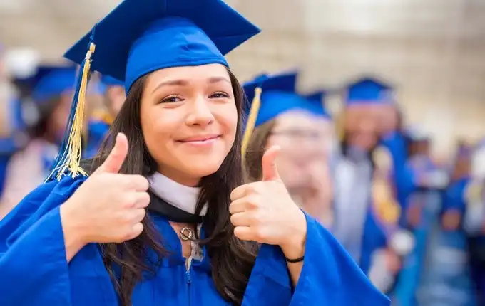 a woman giving a thumbs up in ceremonial robes