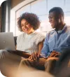 A man and a woman working on a computer