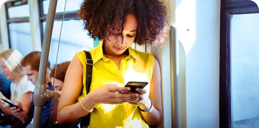 a woman typing on a cell phone