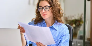 a woman with healthcare accounting training looking over a company’s financial documents