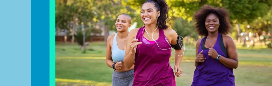 Three ladies running and smiling to improve their heart health