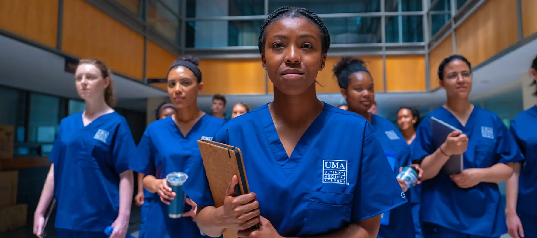 A person wearing UMA-embroidered scrubs