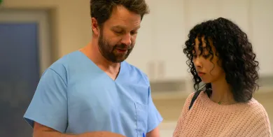 a medical assistant explaining healthcare paperwork to a patient