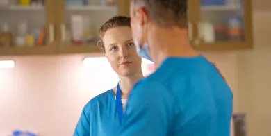 two medical administrative assistants talking in a doctor’s office