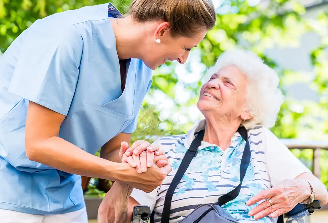 A medical assistant assists an elderly patient