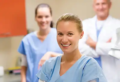 Three healthcare professionals at work in a medical setting