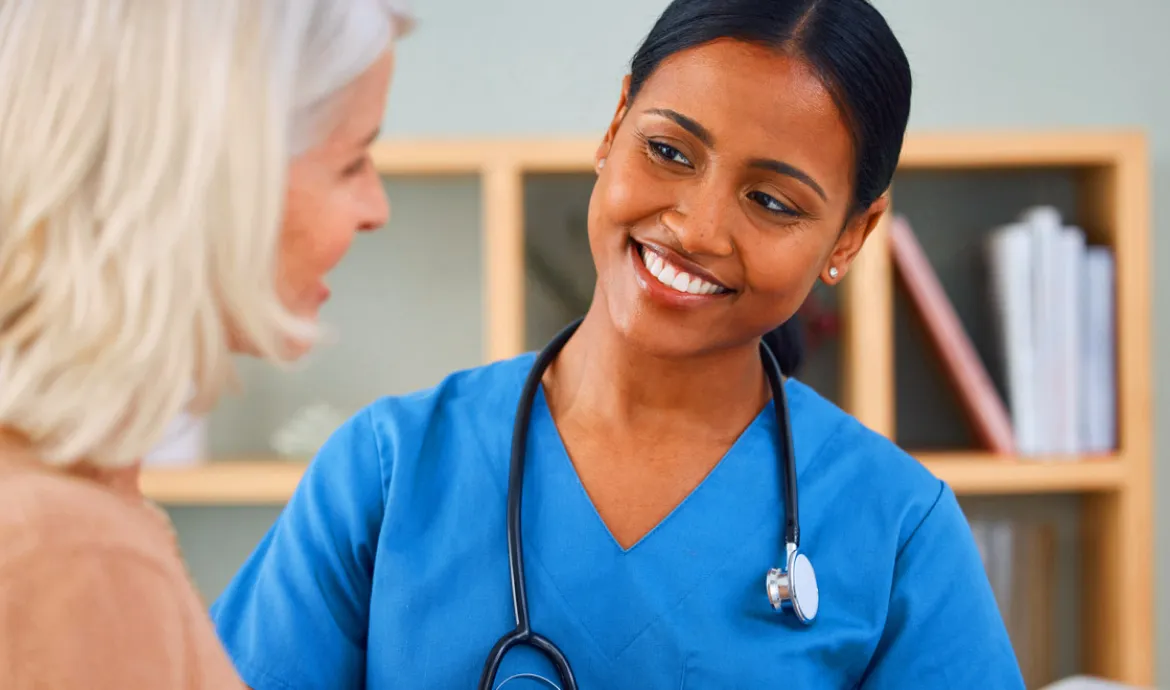 a patient care technician talking to a patient in an office setting