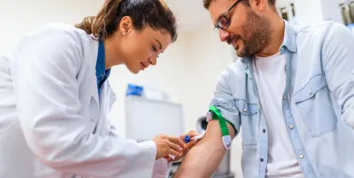 a phlebotomy technician preparing to draw blood from the right arm of an adult patient