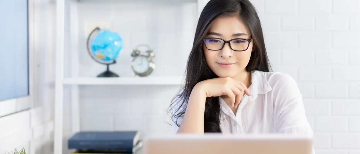 lady with smile looking at computer