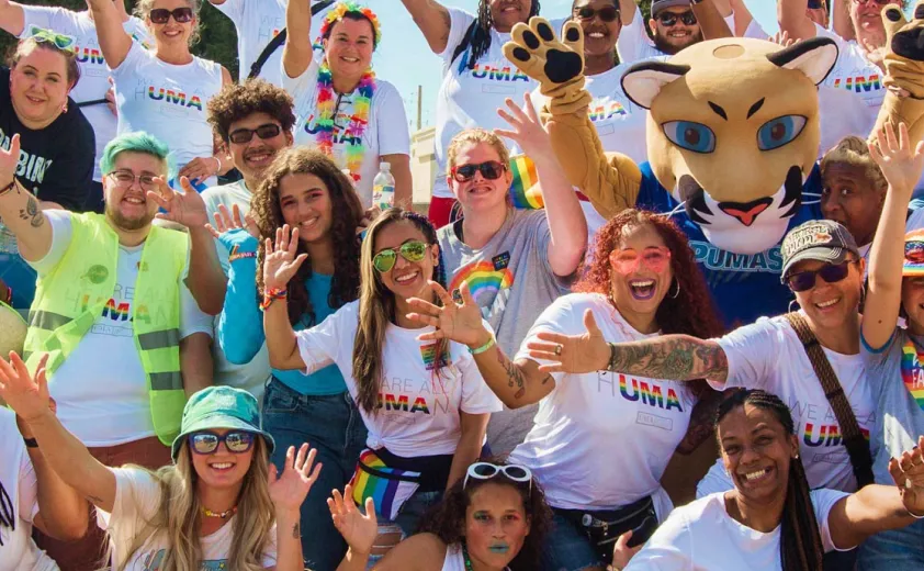 A group of UMA advocates with Journey the Puma mascot