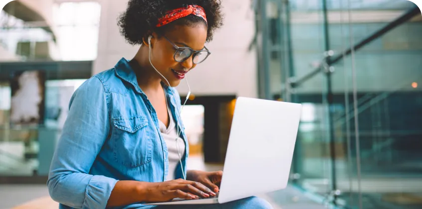 a woman typing on a laptop computer